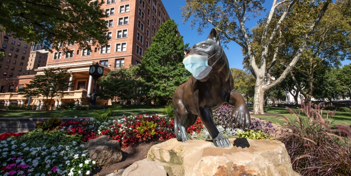 Panther Stature in front of Union with a COVID mask on
